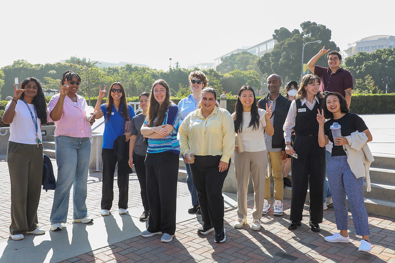 New Student Affairs staff standing outside the Barclay theatre and smiling.