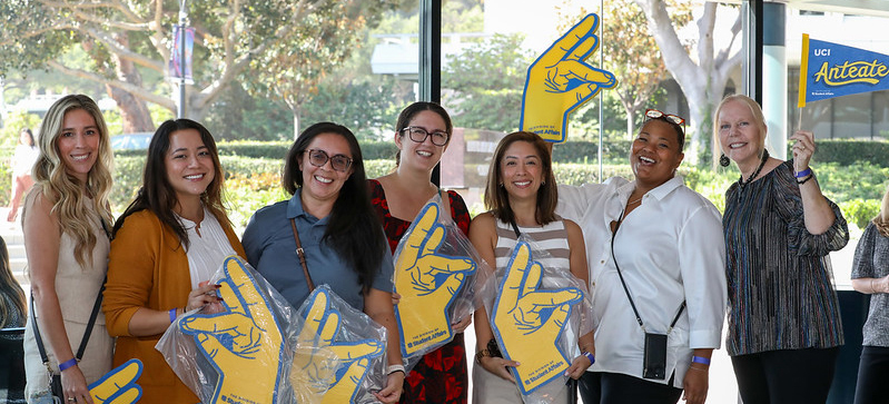 Employees holding their new zot foam hands.