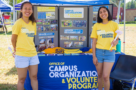 photo of two students standing in front of Campus Orgs and Volunteer Programs info booth